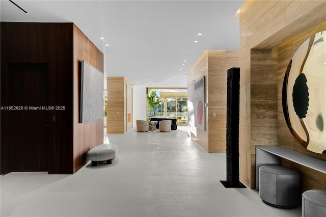 hallway with a wall of windows and wood walls