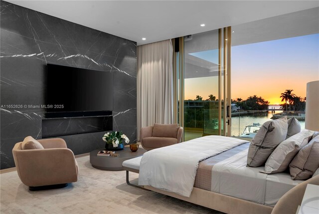 carpeted bedroom featuring a wall of windows and multiple windows