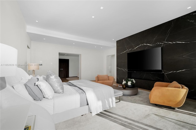 carpeted bedroom featuring beam ceiling and tile walls