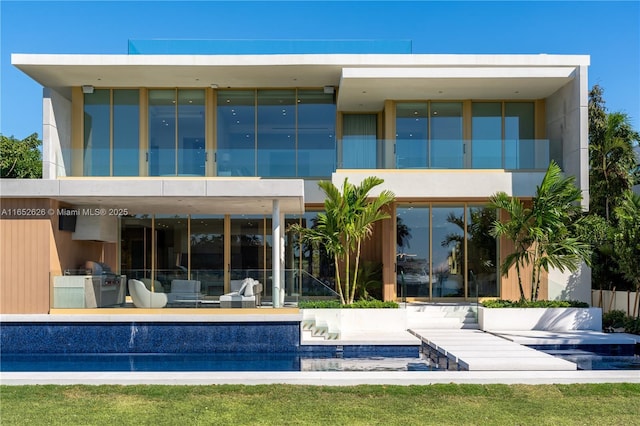 rear view of house featuring a patio area and a balcony