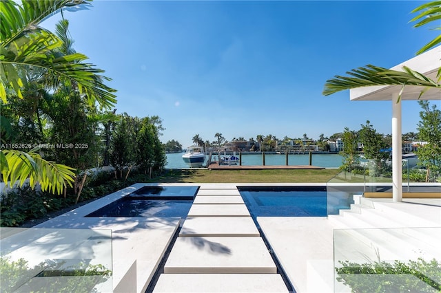 view of swimming pool with a lawn and a water view