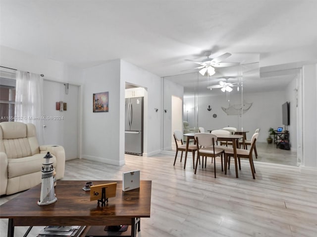 living room featuring light wood-type flooring and ceiling fan