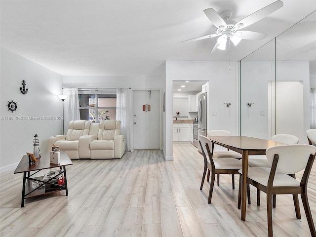 living room with light hardwood / wood-style flooring and ceiling fan