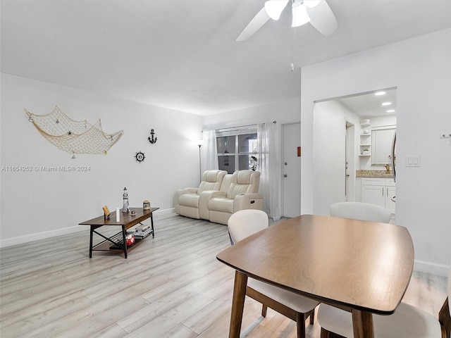 living room with light wood-type flooring and ceiling fan