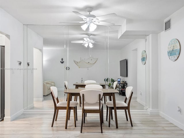 dining area with light hardwood / wood-style flooring and ceiling fan