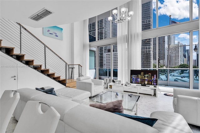 living room with an inviting chandelier and a towering ceiling