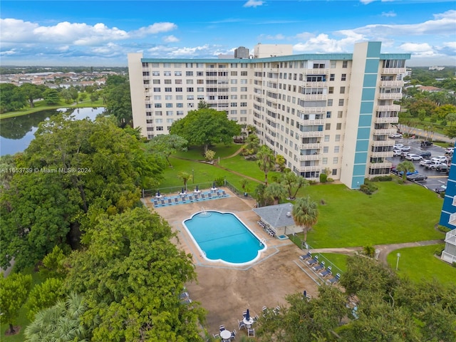 view of pool featuring a water view and a patio