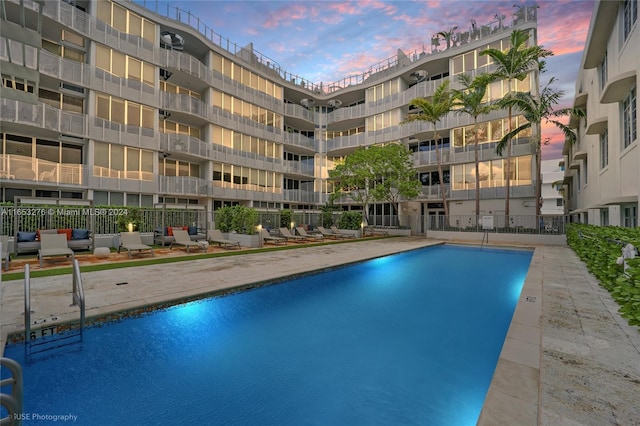 view of pool at dusk