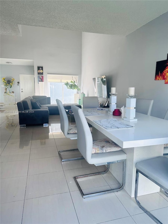 dining room with light tile patterned floors and a textured ceiling