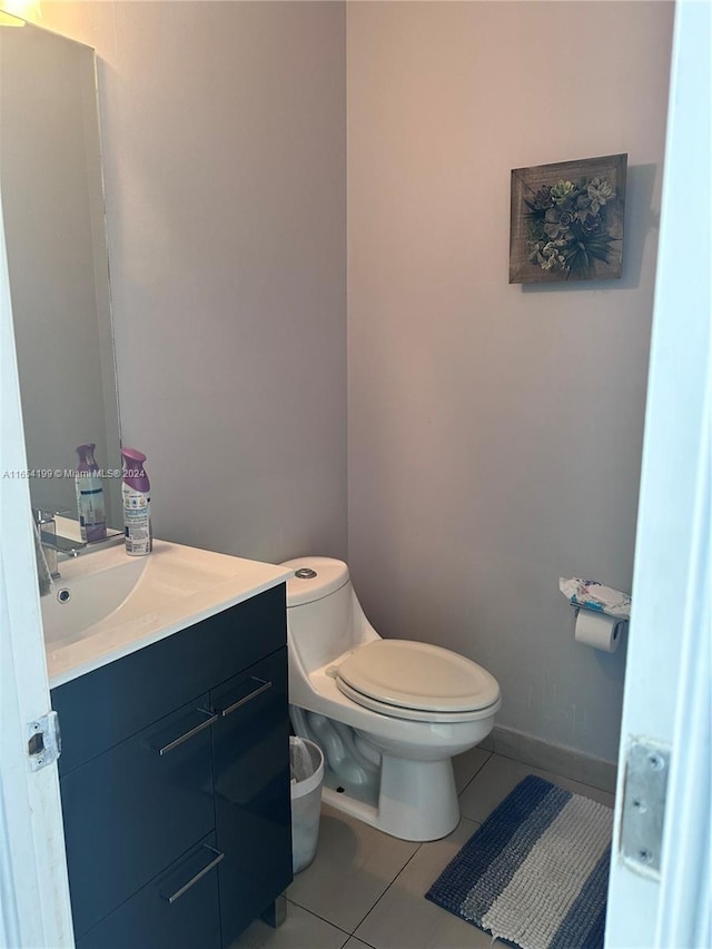 bathroom featuring tile patterned flooring, vanity, and toilet