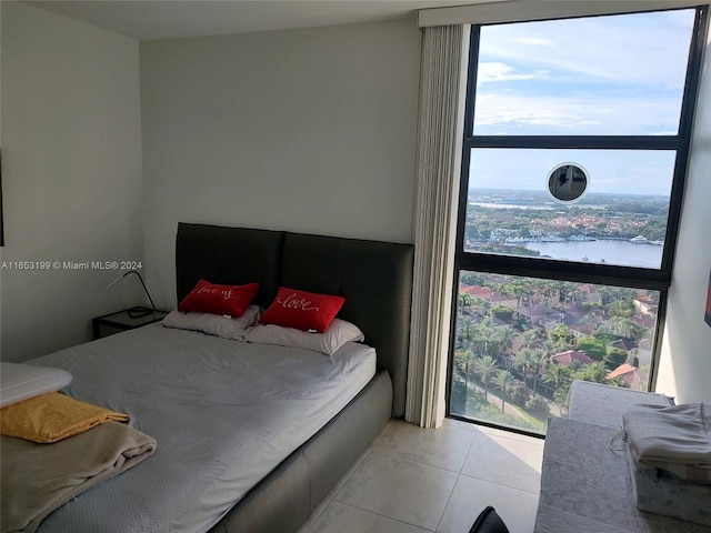 tiled bedroom featuring a water view