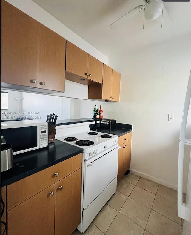 kitchen with white appliances, light tile patterned floors, and ceiling fan