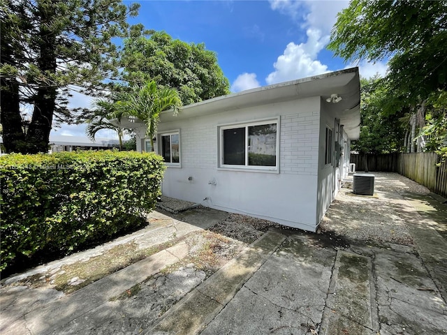 view of property exterior featuring a patio area and cooling unit