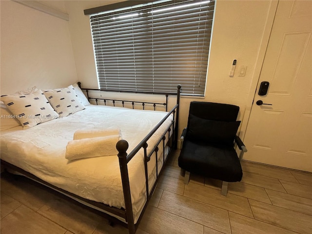 bedroom with wood-type flooring