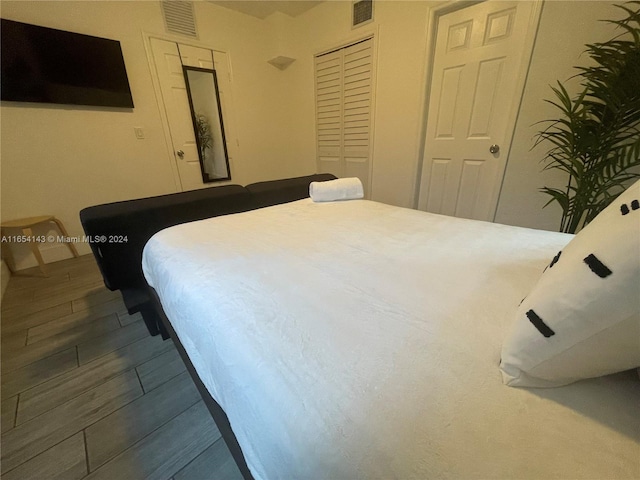 bedroom featuring hardwood / wood-style floors and a closet