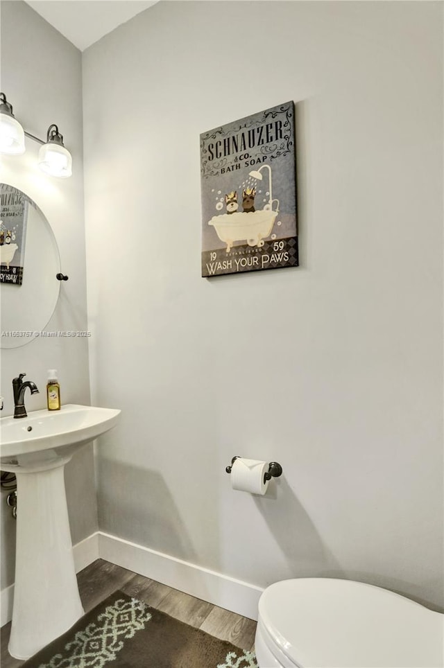 bathroom featuring sink, hardwood / wood-style flooring, and toilet