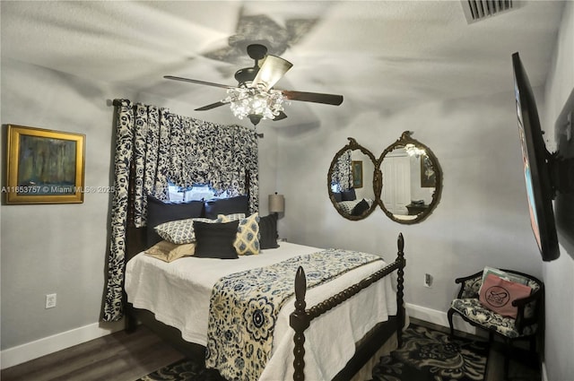 bedroom with ceiling fan, dark hardwood / wood-style flooring, and a textured ceiling