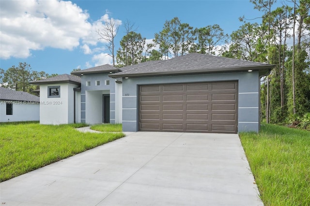 prairie-style home with a garage and a front yard