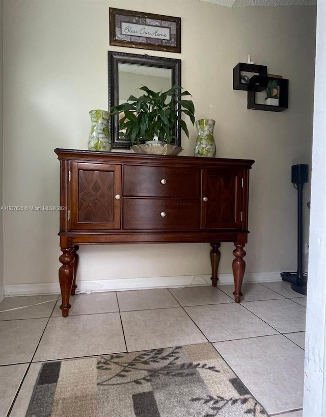 miscellaneous room with light tile patterned floors