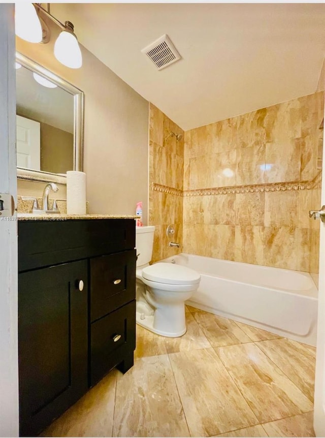 full bathroom with vanity, toilet, and tiled shower / bath combo