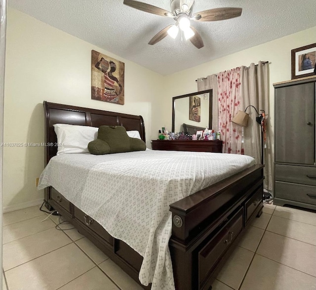 tiled bedroom featuring a textured ceiling and ceiling fan