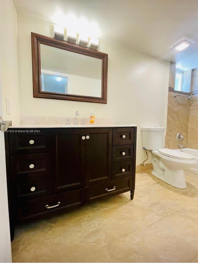 full bathroom featuring toilet, tiled shower / bath combo, and vanity