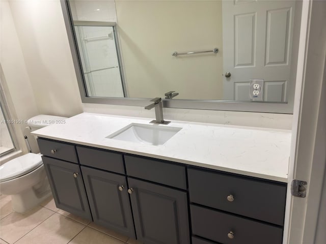 bathroom with tile patterned flooring, a tile shower, vanity, and toilet