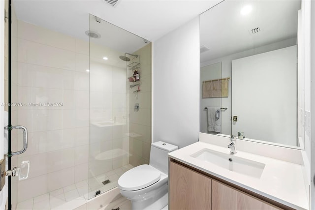 bathroom with visible vents, toilet, a stall shower, and vanity