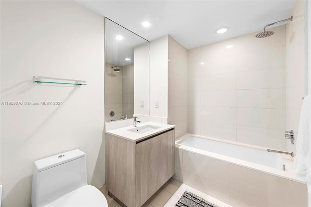 bathroom featuring tile patterned floors, tiled shower / bath, toilet, recessed lighting, and vanity