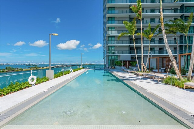 view of pool with a water view