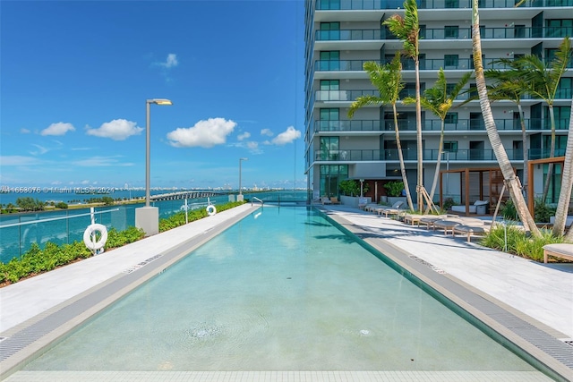 view of swimming pool featuring a water view