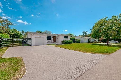 ranch-style home featuring a front yard