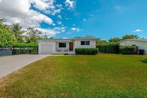 single story home with a front lawn and a garage