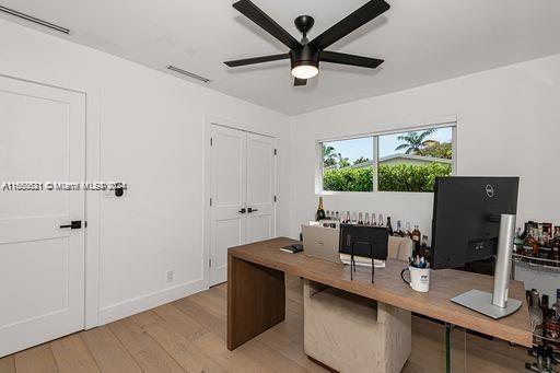 office space with ceiling fan and light hardwood / wood-style flooring