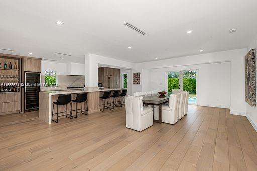 dining space featuring light hardwood / wood-style flooring and indoor bar