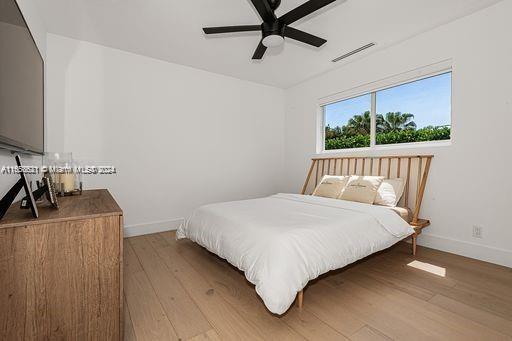 bedroom with ceiling fan and hardwood / wood-style flooring