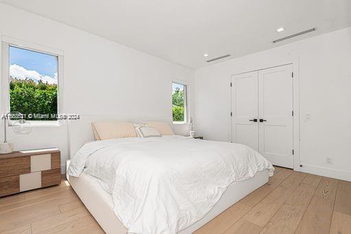 bedroom featuring a closet and light hardwood / wood-style floors