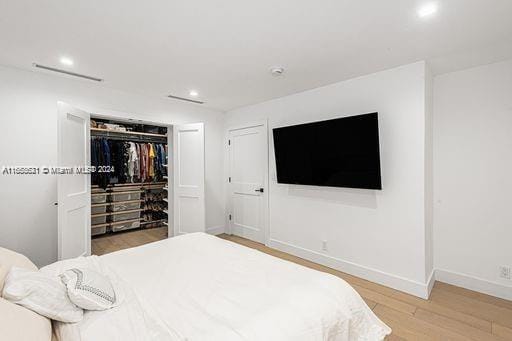 bedroom featuring a closet and light hardwood / wood-style floors