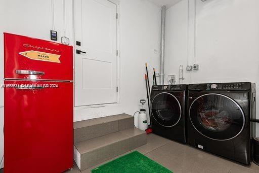 laundry area with tile patterned floors and separate washer and dryer