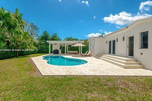 view of pool featuring a yard and a patio area