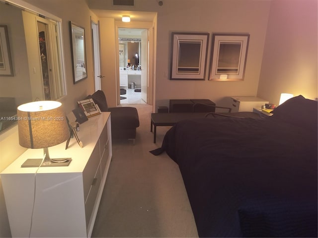 carpeted bedroom featuring visible vents