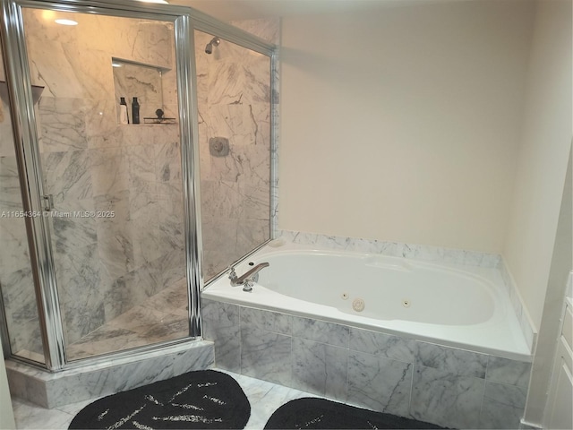 bathroom with a stall shower and a jetted tub