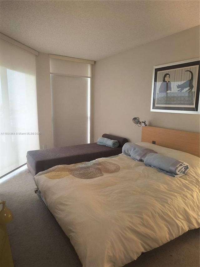 carpeted bedroom featuring a textured ceiling