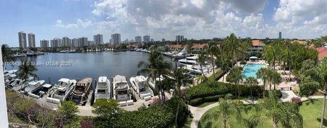 birds eye view of property featuring a water view and a view of city