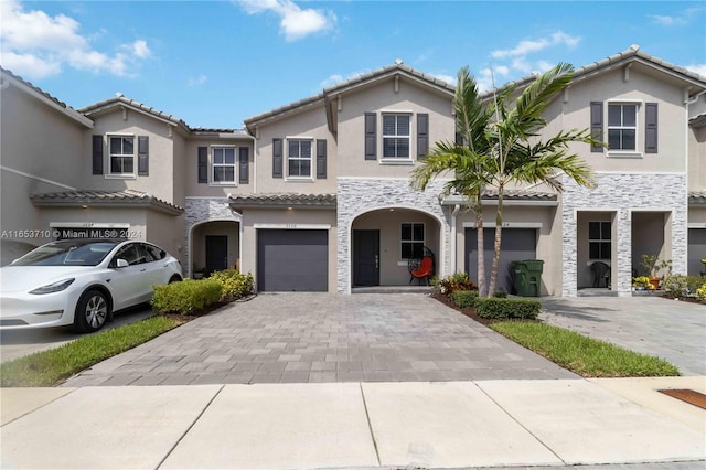 mediterranean / spanish-style home with a garage