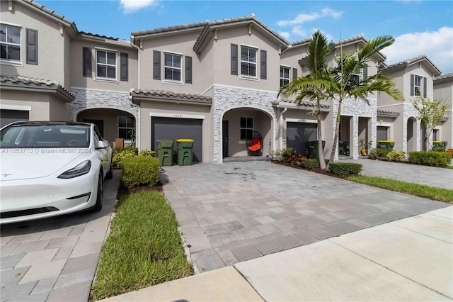 mediterranean / spanish-style house with a garage