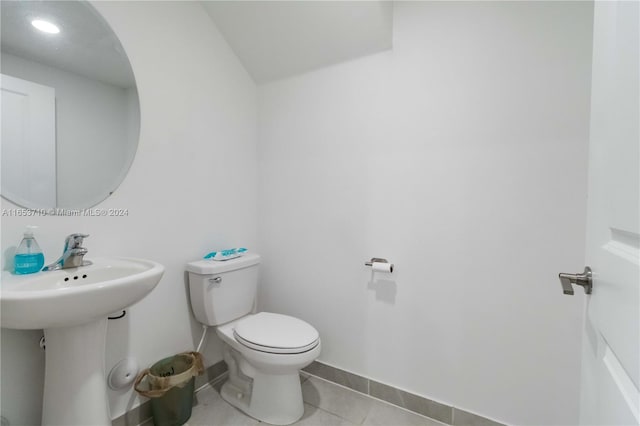 bathroom with tile patterned flooring, toilet, and sink