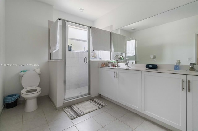 bathroom featuring vanity, toilet, an enclosed shower, and tile patterned flooring