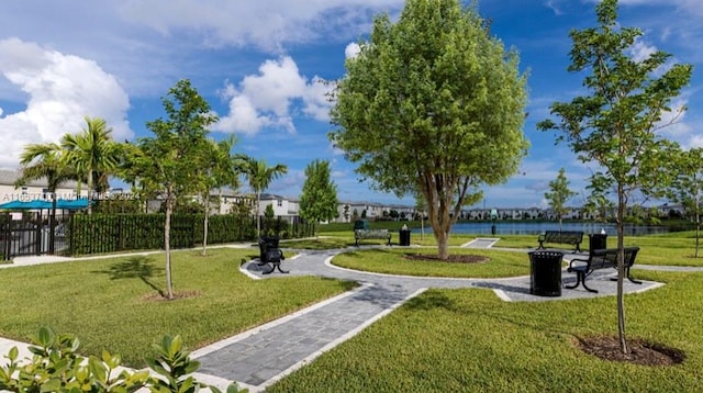 view of property's community featuring a water view and a lawn