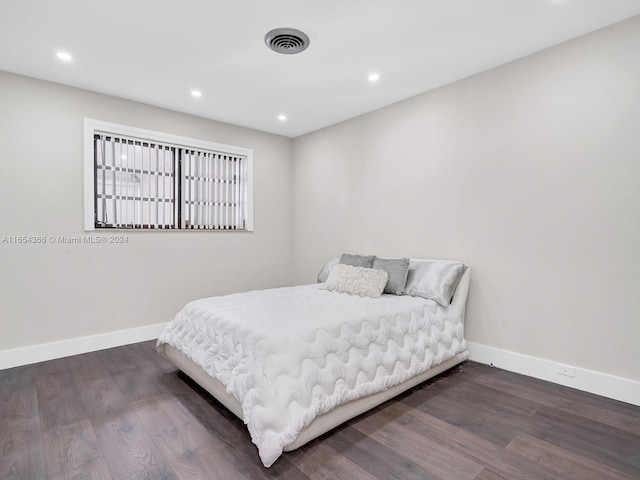 bedroom featuring dark hardwood / wood-style flooring